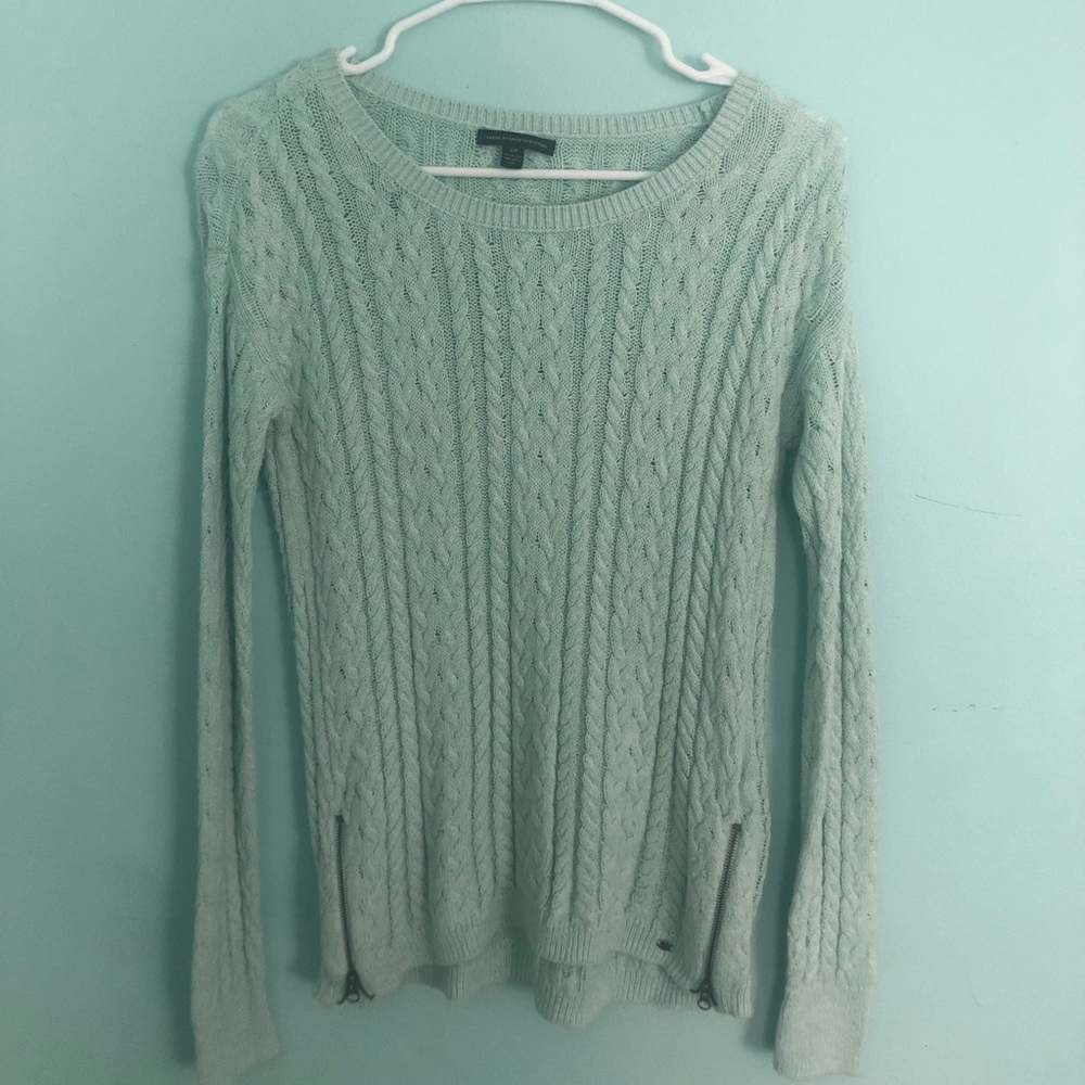 mint green cable knit sweater with zippers.